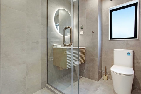The shower is a modern glass box.