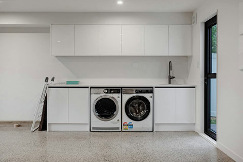 There is a washing machine and dryer in the garage area.