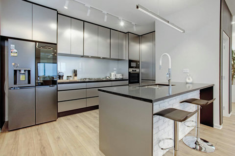 The kitchen has a gas cooktop, oven, microwave, fridge/freezer and dishwasher.