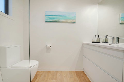 The main family bathroom has a shower, vanity and toilet.