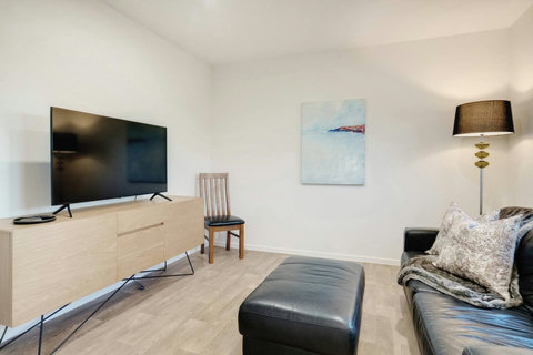 Relax on the couch and watch the TV or read a book.