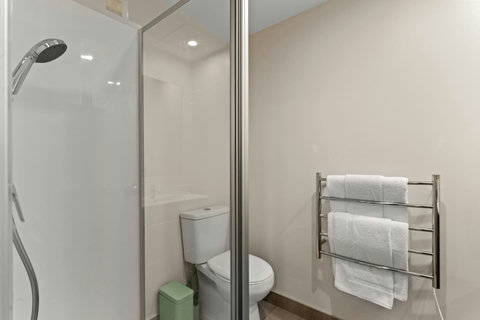 The main bathroom has a shower, toilet and vanity unit.
