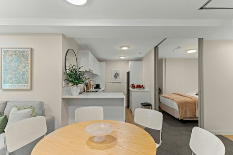 One of the Queen bedrooms is located off the main living space by the kitchen.