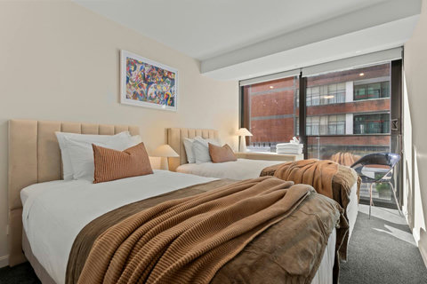 There are floor-to-ceiling windows in the twin bedroom.