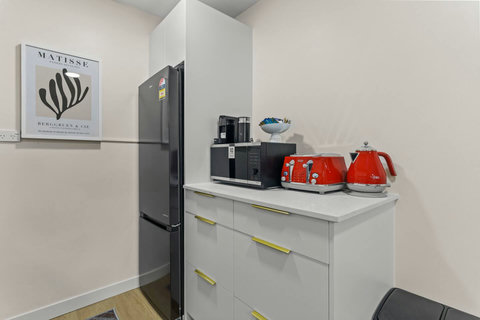 The red appliances adds a pop of colour to the kitchen area.