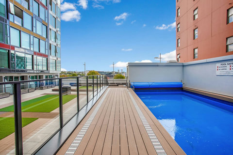 The swimming pool is beside the courtyard area.