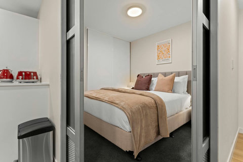 The white sheets invite you to rest and relax in this comfy bed.