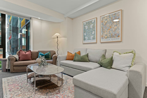 The living room gives off warm, cosy vibes with throws and plenty of cushions.