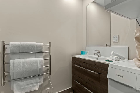 You can undress in the bathroom and put your clothes straight into the washer.