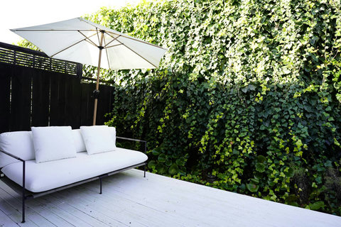 The deck area has outdoor furniture and an umbrella for those sunny days.