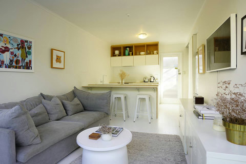 The couch looks very comfy for watching TV and reading a book.