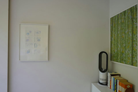 There is a book corner and airfan in the corner of the bedroom.