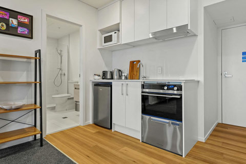 The kitchen has a cooktop, oven, microwave, mini-fridge and dishdrawer.