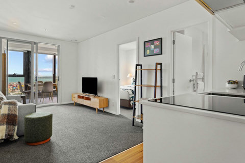 The open-plan living area with kitchen and opening onto the conservatory area.
