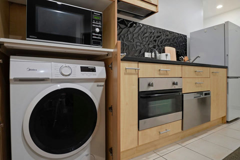 There is a handy washing machine in the kitchen area.