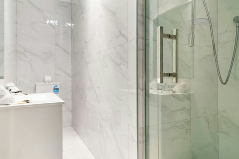 The main bathroom has a shower, toilet and vanity unit.