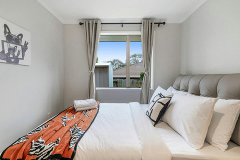 The Queen bed has lots of natural light streaming into the room.