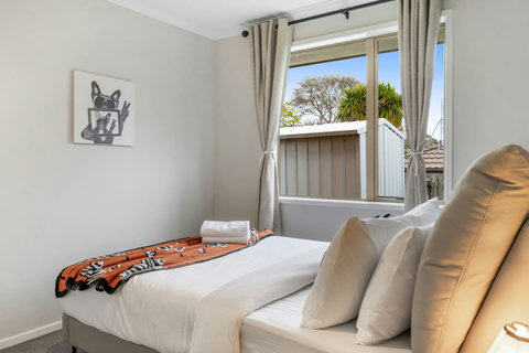 The pop of orange from the throw adds some colour to the neutral background.