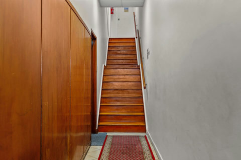 A flight of stairs of about 15 steps leads to the apartment door