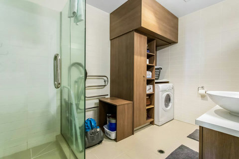 There are some cleaning supplies stored in the bathroom area.