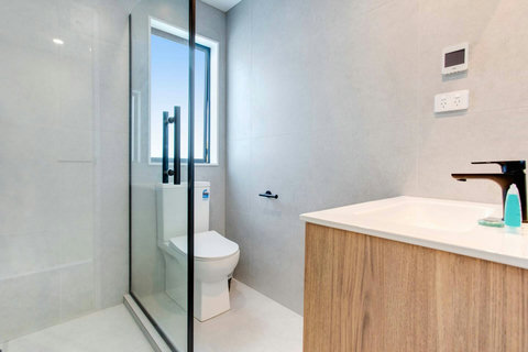 The main family bathroom has a shower, vanity and toilet.