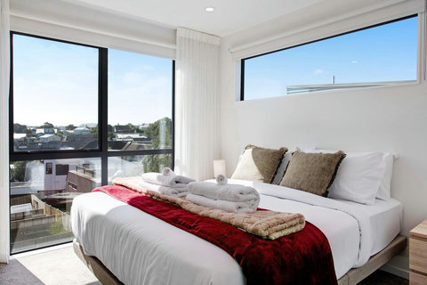 The Queen bedroom has pops of colour against the neutral background.