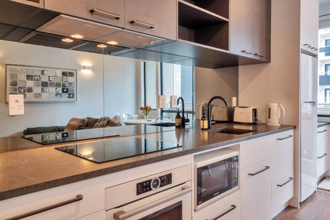 The kitchen is well-equipped with an oven, cooktop, microwave, fridge/freezer and dish drawer.