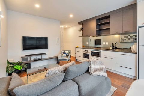 This open-plan living space is a great use of space with the kitchen along the wall, living room and dining space in the centre.
