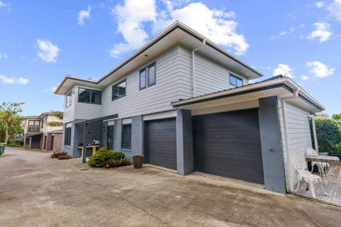 View of the house with the entryway and parking outside the garage.