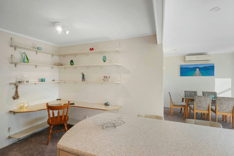 A great use of space between the kitchen and living room is a handy desk area.