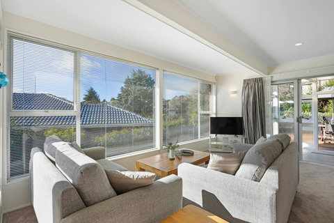The living space is airy and bright with lots of natural light through the large windows.