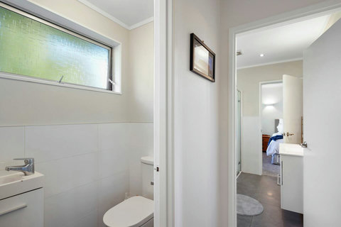 There is a separate toilet with its own wash basin.