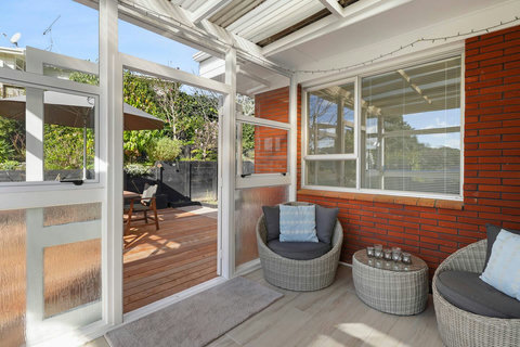 The conservatory opens onto the deck and garden area.