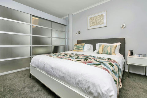 Separate bedroom with kingsize bed for you to luxuriate in. Glass wall divider. Decorated in pastels and splashes of colour.