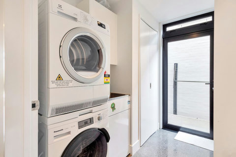 The separate laundry has a front-loading washing machine and dryer.