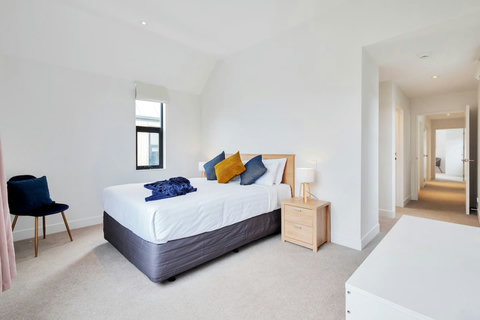 The main bedroom has a large walk-in wardrobe and a full ensuite bathroom.