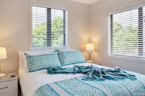 This bedroom has plenty of natural light, but you can shut the blinds to make it darker.