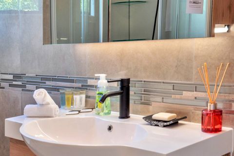 The bathroom has modern fittings throughout.