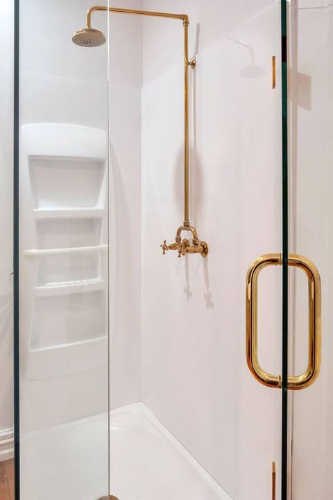 Large built-in shower with antique period features.
