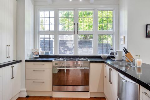The kitchen has plenty of natural light flooding through the large windows.