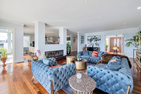 The drawing room has a lovely blue Chesterfield sofa that furnishes the space and gives it a sophisticated, luxurious, cosy, and comfy finish.