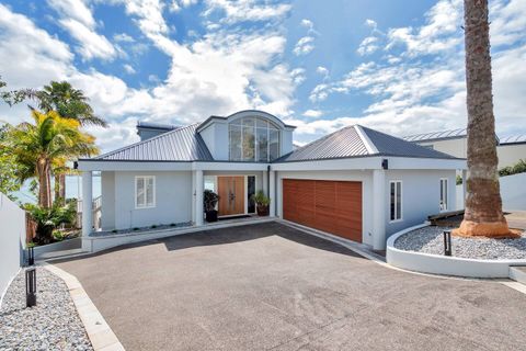 Formal entrance with palm trees and plenty of off-street parking,  you can just see the view poking through which reveals itself fully inside.