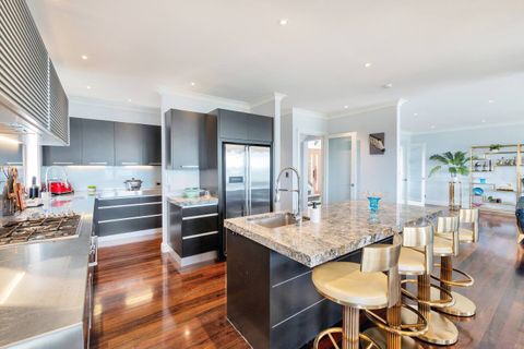 The kitchen is Chef’s dream: a gas cooktop, oven, double-door fridge/freezer, and butler's pantry.