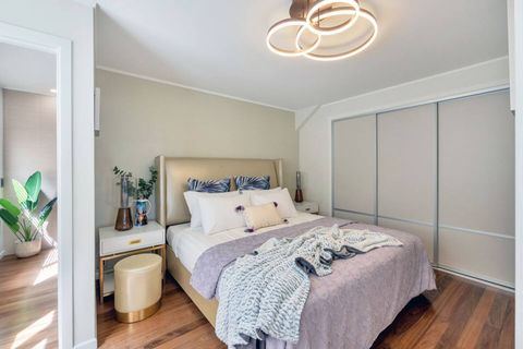 This mauve suite has polished wooden floors, a large wardrobe, and an ensuite bathroom.