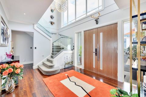 The two-storey Art Deco-style entry foyer is light, airy and welcoming.