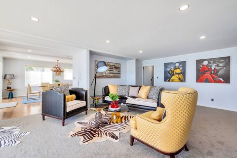 This gentlemen's club-style living room has a distinctly masculine vibe with leather-finished couches and relaxed artwork.