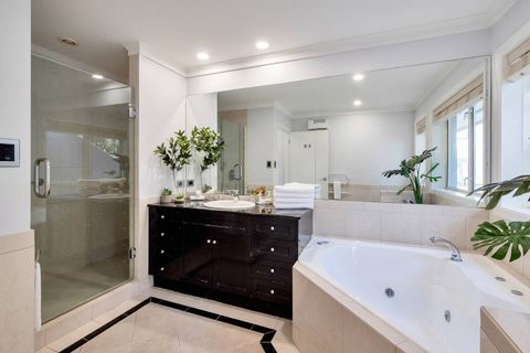 The family bathroom has a spa bath, a double shower, a vanity unit and a toilet.