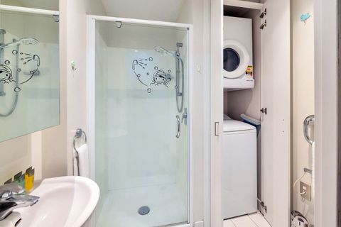 The bathroom also contains a washing machine and a front-loading dryer for you to use.