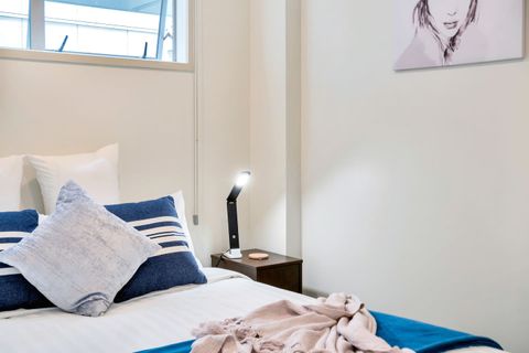 This cosy room comes with stylish bedside tables and night lamps.