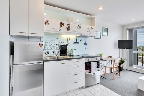 The kitchen is fitted with an oven, glass cooktop, dish draw and full-size fridge.